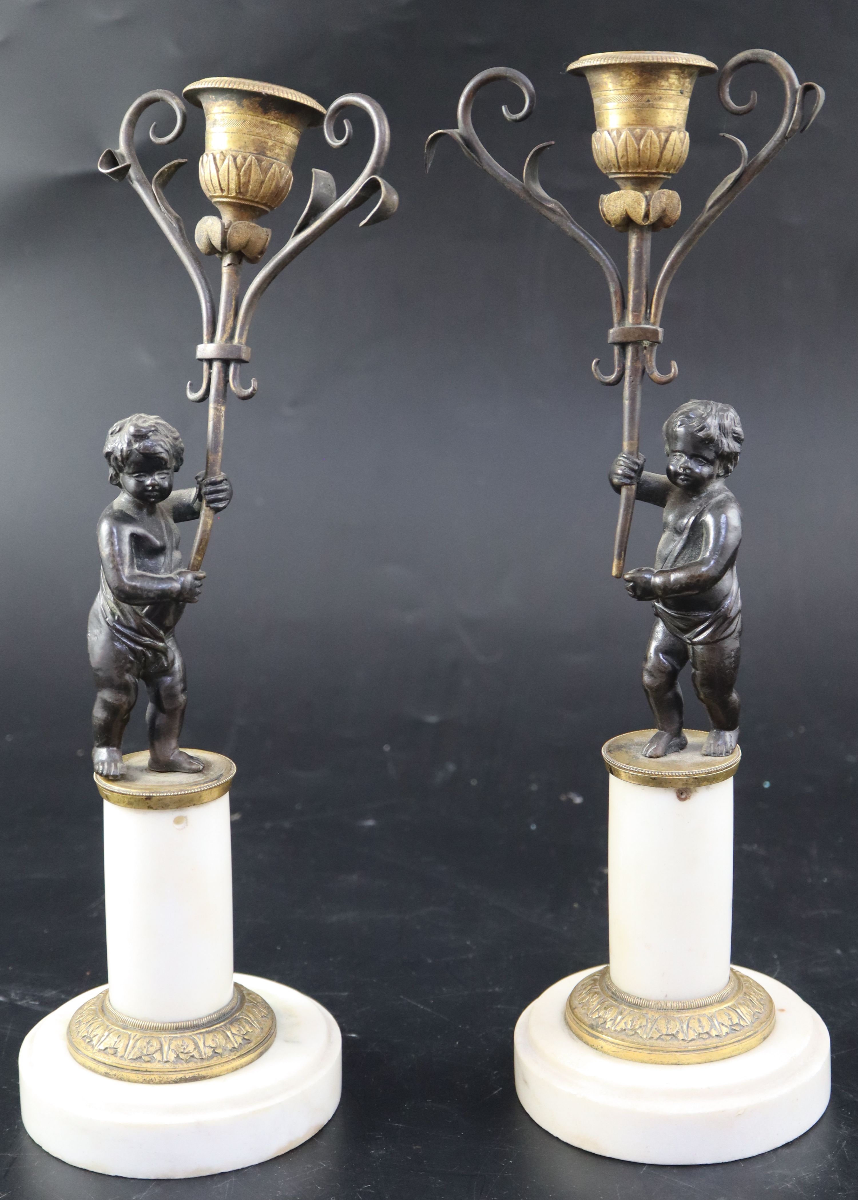 A pair of 19th century French bronze and ormolu candelabra, modelled with putti holding scrolling branches